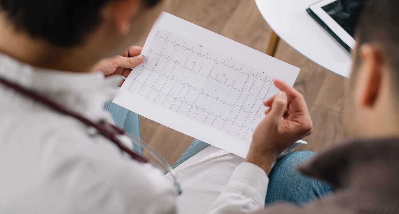 a doctor looking at an ekg printout